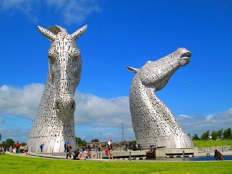 two silver horse head sculptures